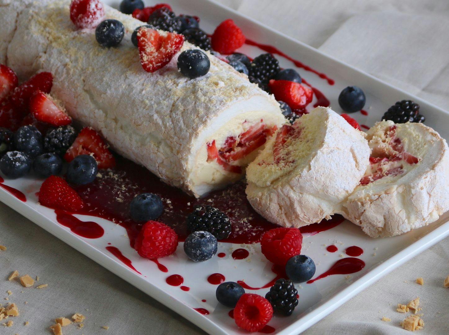 Meringue roulade with fresh berries and white chocolate